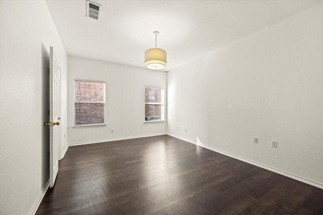 empty room with dark wood-type flooring