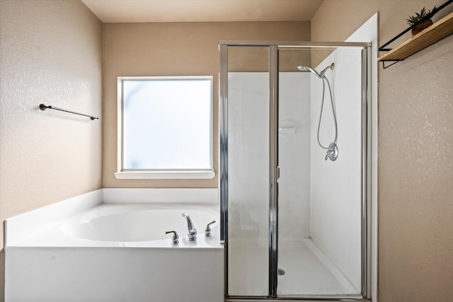 bathroom featuring shower with separate bathtub