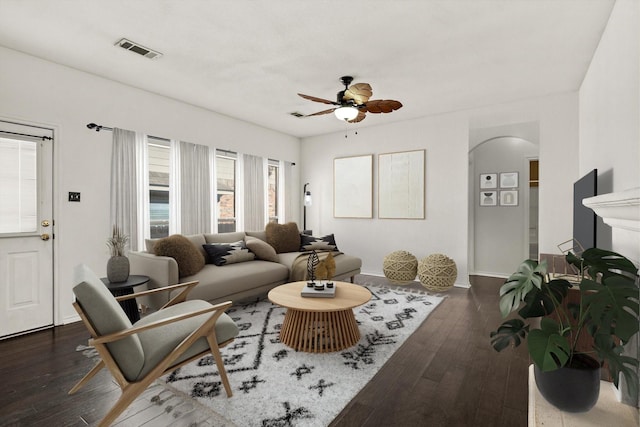 living room with ceiling fan and dark hardwood / wood-style floors