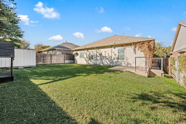 rear view of property featuring a patio area, a yard, and a shed