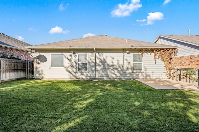 back of house featuring a yard and a patio