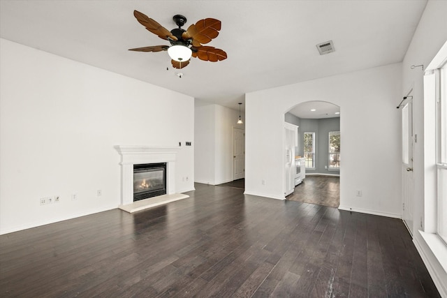 unfurnished living room with dark wood-type flooring and ceiling fan