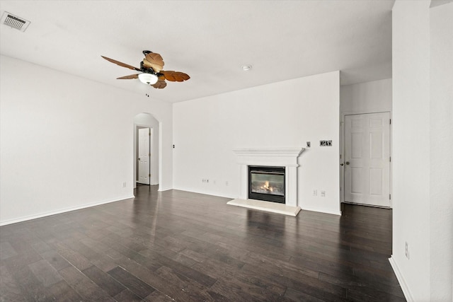 unfurnished living room with ceiling fan and dark hardwood / wood-style flooring