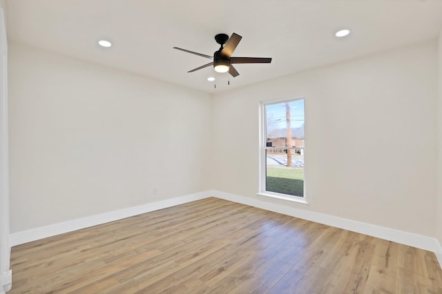 empty room featuring ceiling fan and light hardwood / wood-style flooring