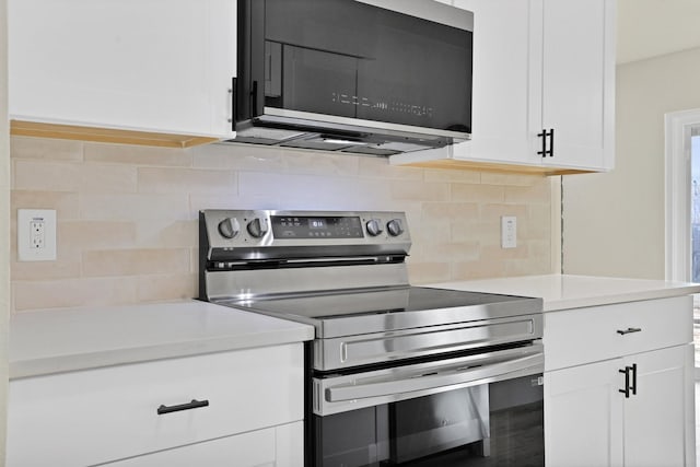 kitchen with stainless steel range with electric cooktop, white cabinets, and tasteful backsplash