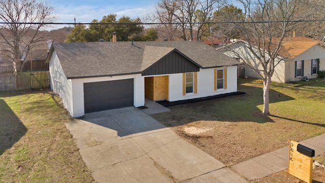 view of front of home featuring a garage and a front yard