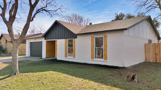 view of front of property with a front yard and a garage