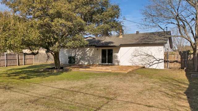 rear view of property with central air condition unit and a lawn