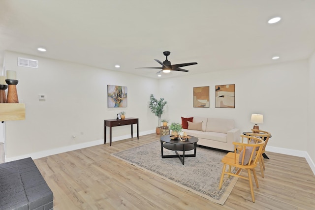 living room featuring light wood-type flooring and ceiling fan