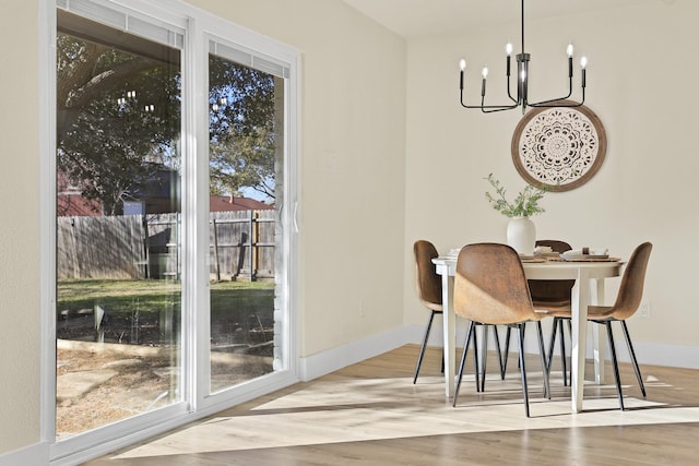 dining space with an inviting chandelier and light wood-type flooring