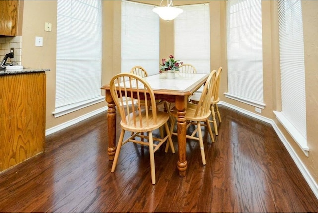 dining space with dark wood-type flooring