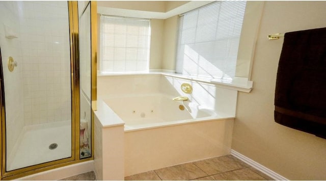 bathroom with tile patterned flooring, a wealth of natural light, and independent shower and bath