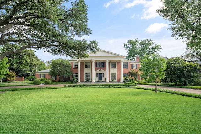 neoclassical / greek revival house featuring a front lawn