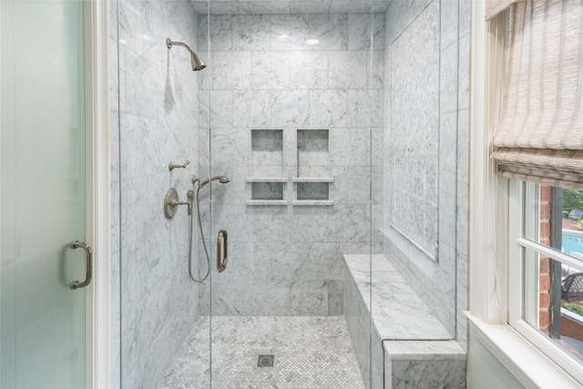 bathroom with walk in shower and plenty of natural light