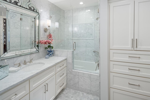 bathroom with shower / bath combination with glass door and vanity