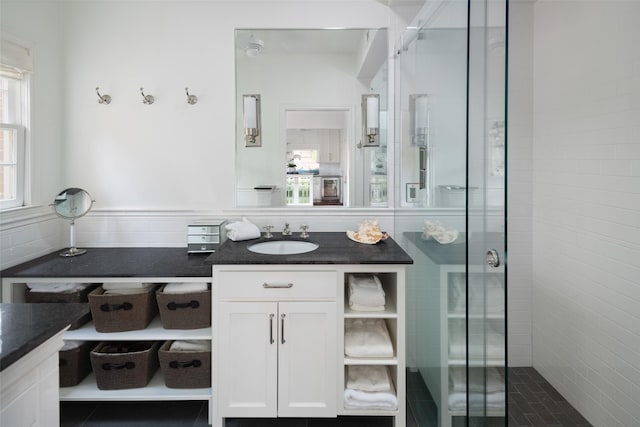 bathroom featuring plenty of natural light, an enclosed shower, and vanity