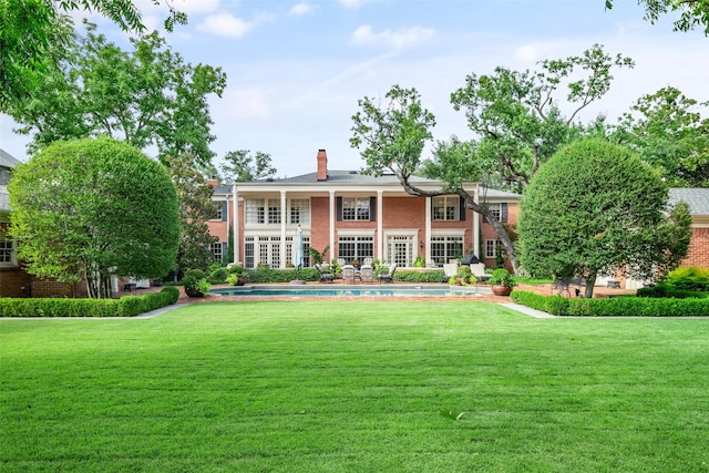 rear view of property with a lawn