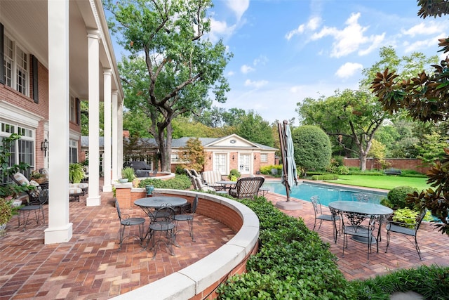 view of swimming pool with an outbuilding and a patio area