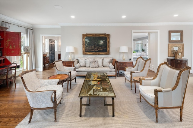 living room with ornamental molding and wood-type flooring