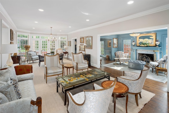 living room featuring ornamental molding, french doors, a high end fireplace, and hardwood / wood-style flooring