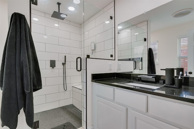 bathroom with walk in shower and vanity