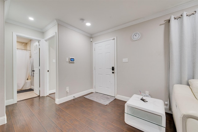 entryway featuring ornamental molding and dark hardwood / wood-style floors