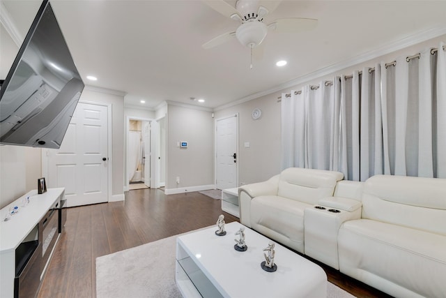 living room featuring ceiling fan, ornamental molding, and dark hardwood / wood-style floors