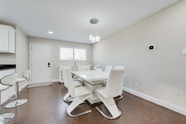 dining space featuring a notable chandelier and dark hardwood / wood-style floors