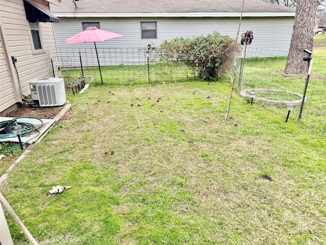 view of yard featuring central AC and a trampoline