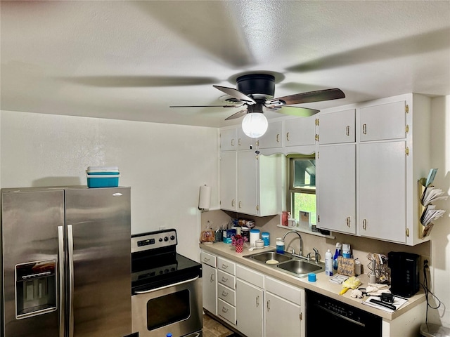 kitchen featuring sink, stainless steel appliances, white cabinetry, and ceiling fan