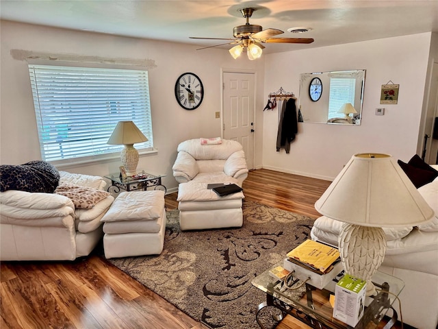 living room featuring ceiling fan and wood-type flooring