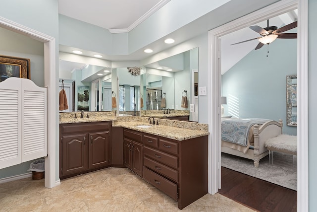 bathroom with wood-type flooring, crown molding, vanity, ceiling fan, and plenty of natural light