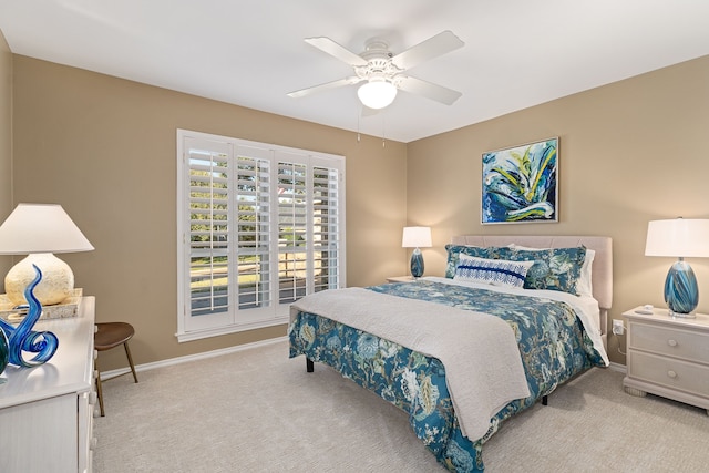 bedroom with ceiling fan and light colored carpet