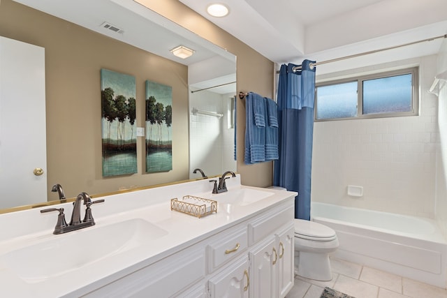 full bathroom with shower / tub combo, vanity, tile patterned floors, and toilet