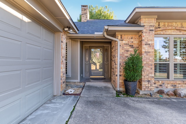 doorway to property with a garage