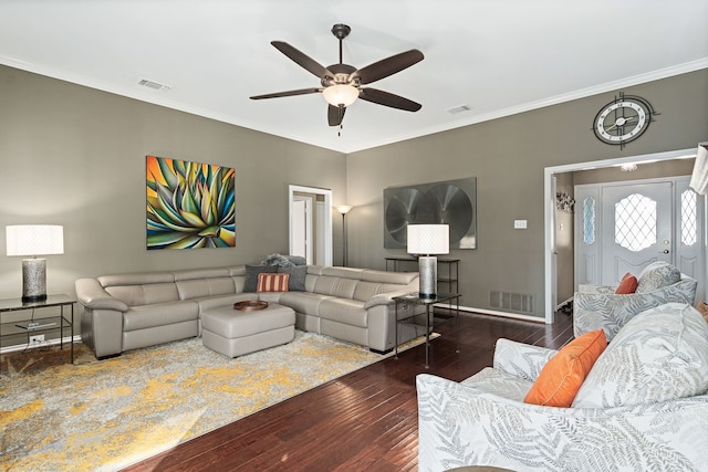 living room featuring ceiling fan, dark wood-type flooring, and crown molding