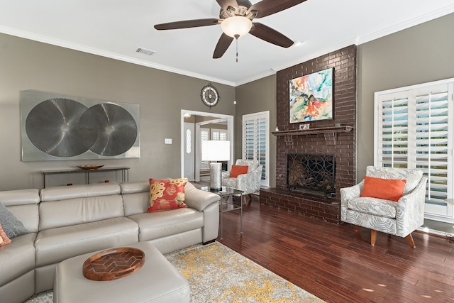 living room featuring a brick fireplace, hardwood / wood-style floors, ceiling fan, and ornamental molding