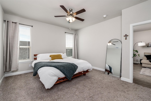 bedroom featuring multiple windows, ceiling fan, and carpet