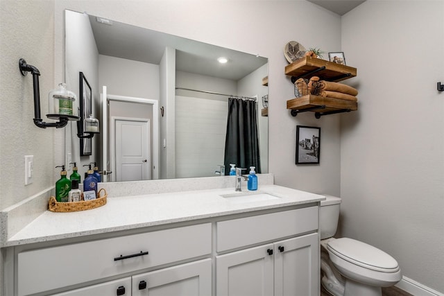 bathroom featuring toilet, curtained shower, and vanity