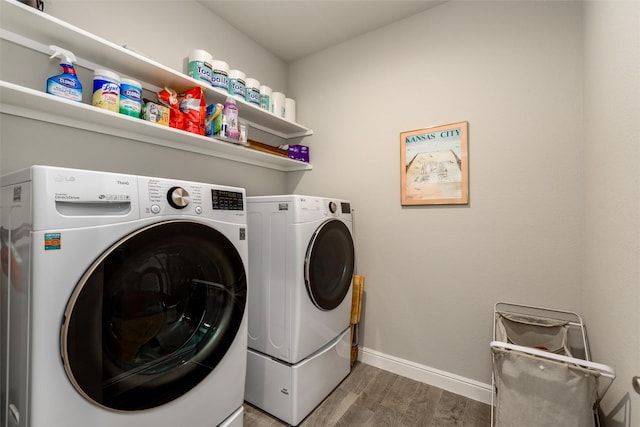 laundry room featuring hardwood / wood-style flooring and washer and clothes dryer