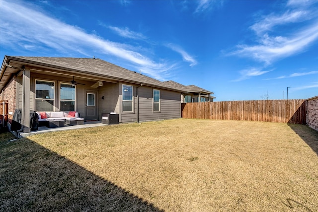 rear view of property with a patio, ceiling fan, a lawn, and an outdoor living space