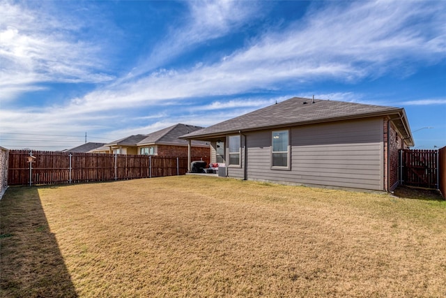 rear view of house with a yard