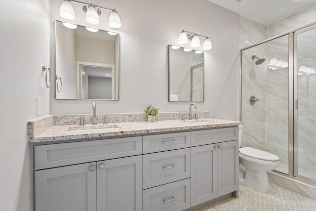 bathroom featuring vanity, tile patterned flooring, a shower with shower door, and toilet