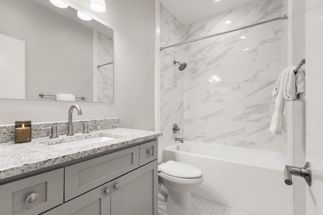 full bathroom featuring toilet, vanity, and tiled shower / bath combo