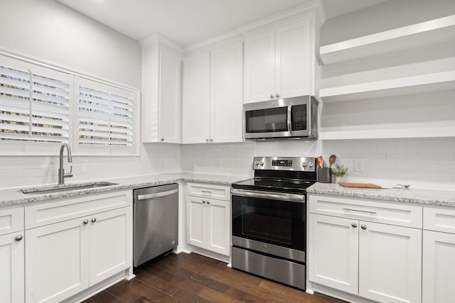 kitchen featuring dark hardwood / wood-style floors, stainless steel appliances, decorative backsplash, white cabinets, and sink