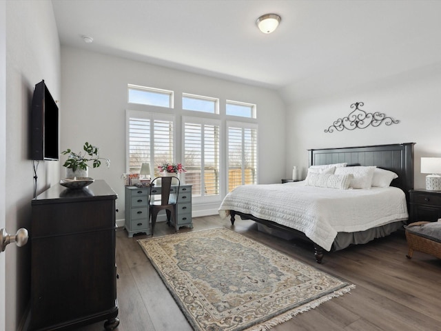 bedroom with lofted ceiling and dark hardwood / wood-style flooring