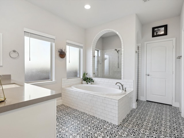 bathroom featuring separate shower and tub, tile patterned flooring, and vanity