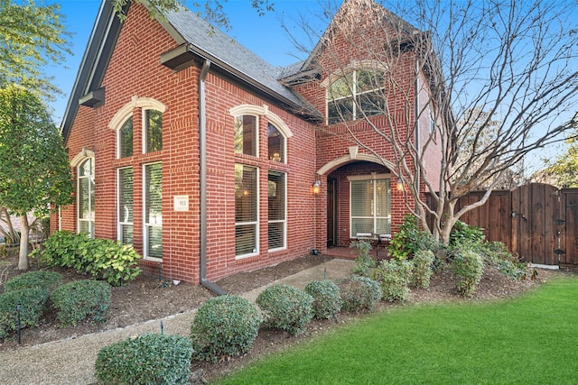 tudor house featuring a front yard