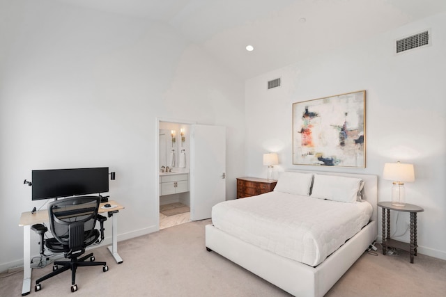 bedroom with sink, ensuite bathroom, vaulted ceiling, and carpet