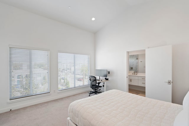 carpeted bedroom featuring high vaulted ceiling and connected bathroom